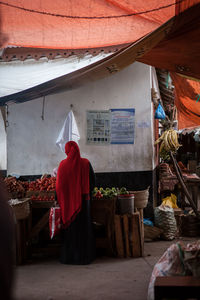 Rear view of a woman buying vegetables