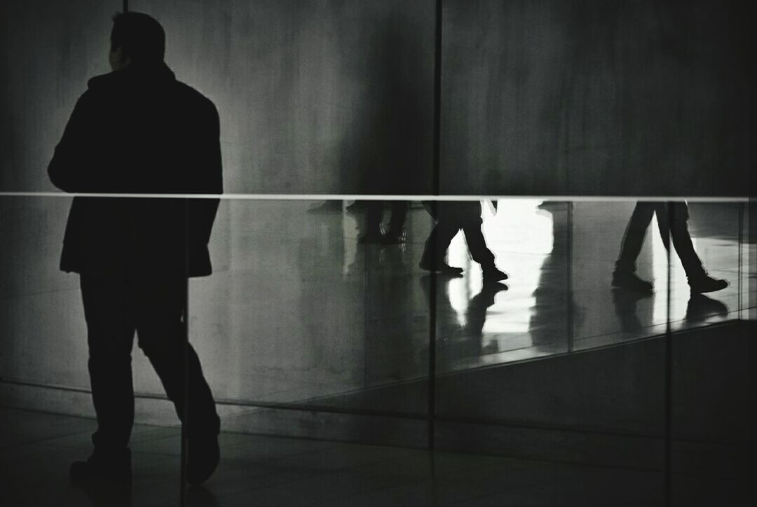 indoors, standing, men, real people, rear view, full length, reflection, walking, women, silhouette, lifestyles, one person, day, people