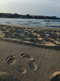 Heart shape on beach against sky