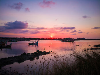 Scenic view of lake against sky at sunset