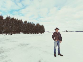 Full length of woman standing on snow covered land