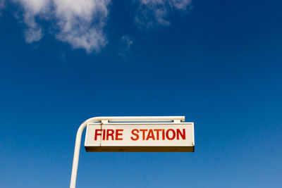 Information sign against blue sky