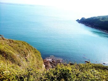 High angle view of rocks by sea against sky