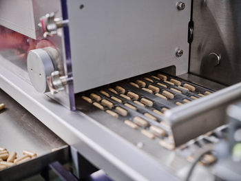 Pills in blisters on metal conveyor in pharmaceutical laboratory