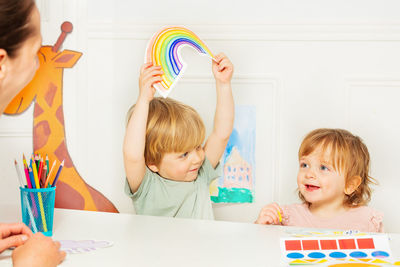 High angle view of boy playing with toys on table