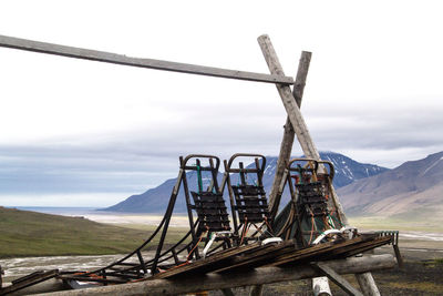 Traditional windmill on mountain against sky