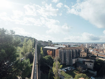 High angle view of buildings against cloudy sky