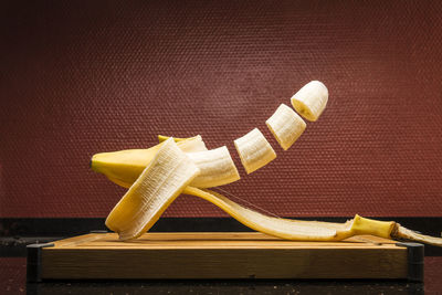 Sliced banana in mid-air over table