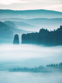 Mountain peak outline in blue night mist. row of foggy mountain ranges in sachsen deutschland park.