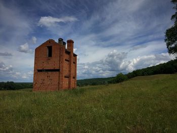 Abandoned house on grassy field