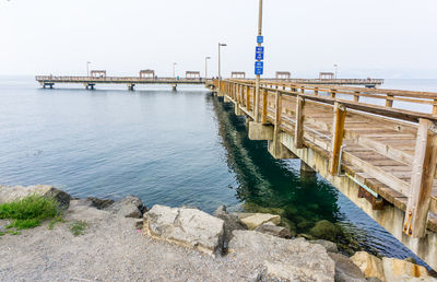 Pier over sea against clear sky