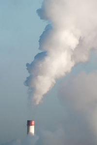 Low angle view of smoke stack against sky