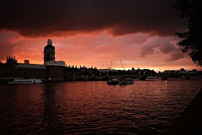 Sailboats in sea against sky during sunset