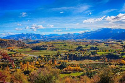 Scenic view of mountains against blue sky