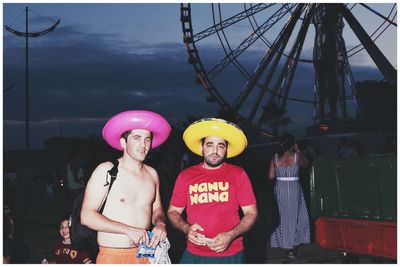 Low angle view of people standing at amusement park