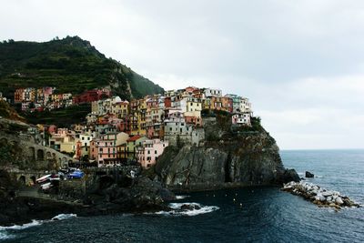 Town by sea against sky
