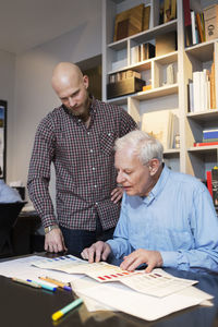 Businessmen choosing color from swatch in office