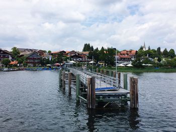 Boat moored at harbor against sky