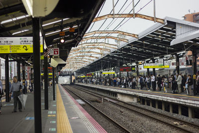 People waiting at railroad station platform
