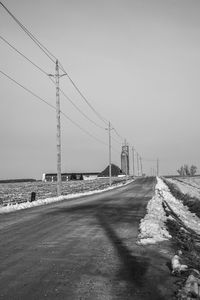 Bridge over road against clear sky