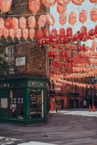 Illuminated market stall by building in city