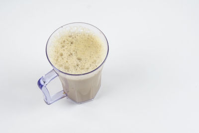 High angle view of coffee cup against white background