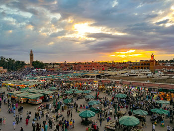 High angle view of people in city against sky during sunset