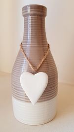 Close-up of heart shape on white table