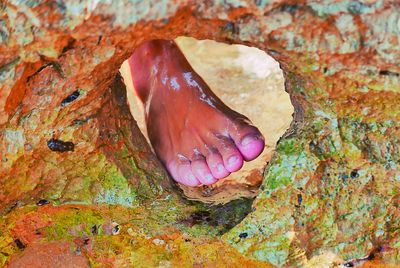 Close-up of women foot in a rock hole
