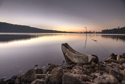 Scenic view of lake against sky during sunset