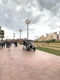 Cars on street in city against sky