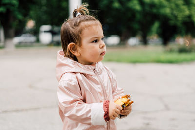 Portrait of cute girl standing outdoors