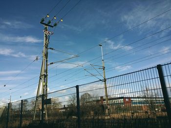 Low angle view of power lines against sky