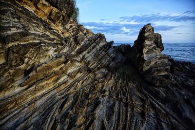 Close-up of eroded rock at beach