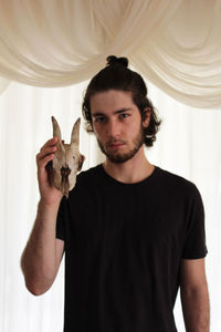 Portrait of man with skull