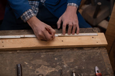 Midsection of man working on table