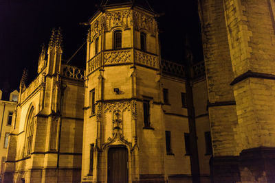 Low angle view of illuminated cathedral against sky at night