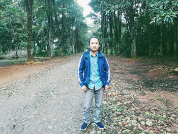 Portrait of man standing in forest