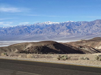 Scenic view of snowcapped mountains against blue sky