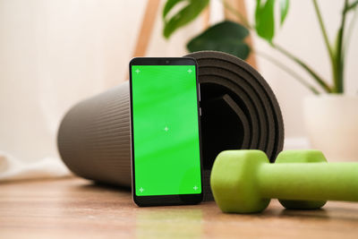 Cropped hand holding equipment on table