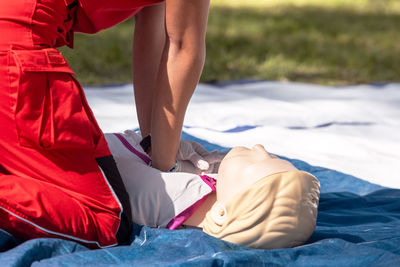 Low section of woman with iv drip at beach