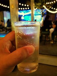 Close-up of hand holding beer glass