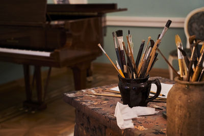 Close-up of paintbrushes on table at home