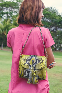 Rear view of woman standing on field