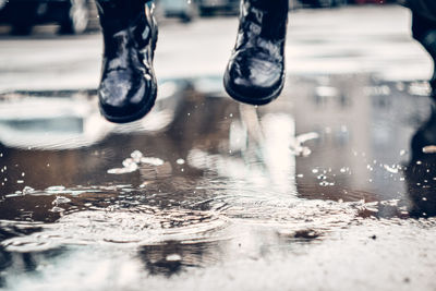 Low section of people in puddle