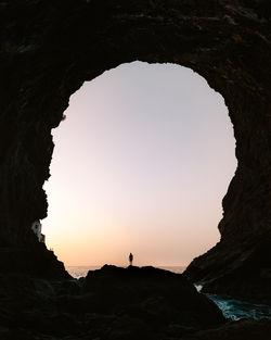 Silhouette of a young men in a great cave on la palma