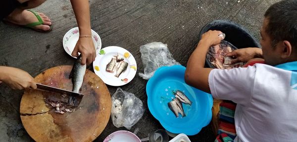 High angle view of people sitting on table