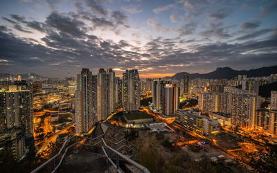 High angle view of illuminated buildings against sky during sunset