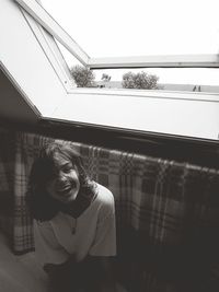 Smiling woman by window