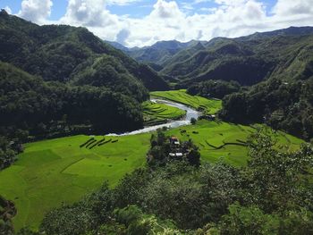 High angle view of green landscape against sky